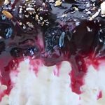 A close-up of a blueberry and crunchy tortilla salad layered in a clear bowl, highlighting the berries and texture of the filling.