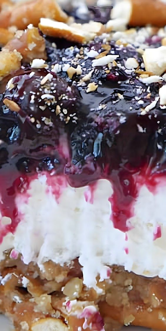 A close-up of a blueberry and crunchy tortilla salad layered in a clear bowl, highlighting the berries and texture of the filling.