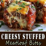Sliced ​​pieces of meatloaf with melted cheese inside, laid out on a wooden board, close-up with an emphasis on the juicy filling.
