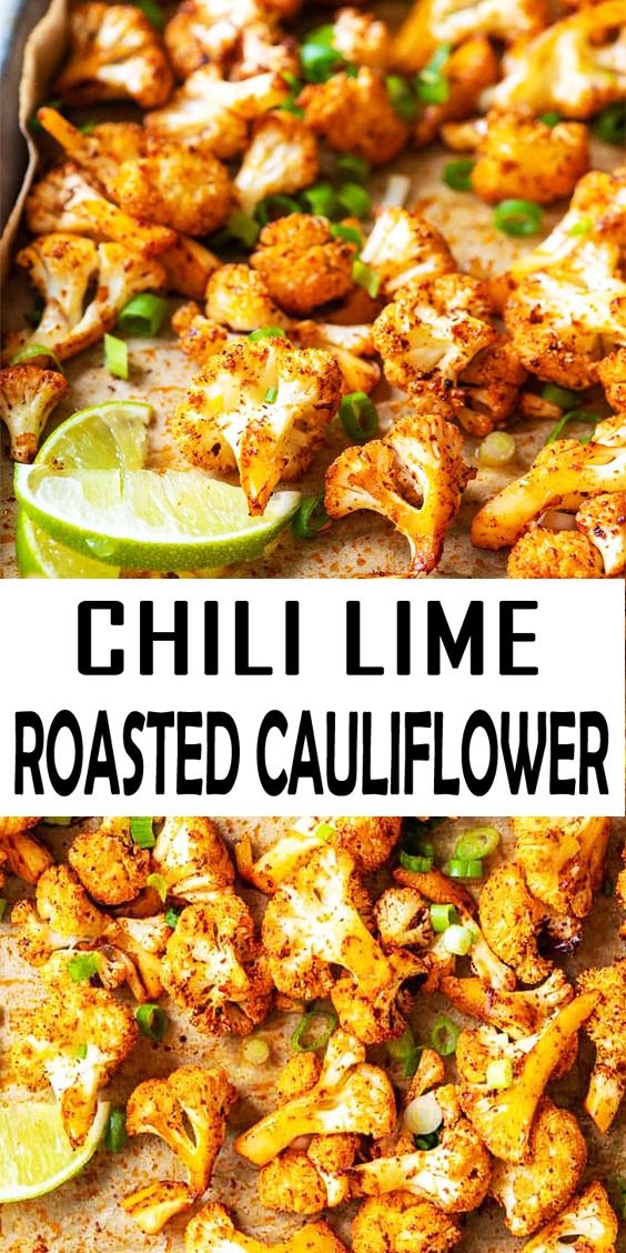 Roasted cauliflower with a golden crust, sprinkled with herbs and lime wedges on a ceramic plate.