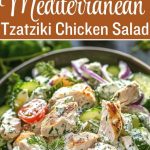 Creamy chicken Tzatziki salad with chicken pieces coated in a yogurt and garlic sauce, fresh cucumbers and herbs, served in a deep white bowl with lemon slices and mint leaves nearby.