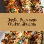 Appetizing chicken skewers, covered with a golden crust with garlic and melted parmesan, served on a wooden board with herbs and lemon wedges.