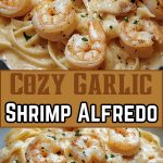 Shrimp in a creamy Alfredo sauce, served with pasta and sprinkled with fresh herbs.