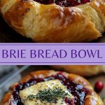 Baked brie cheese melts inside a crisp bread bowl, garnished with cranberry sauce and thyme sprigs.